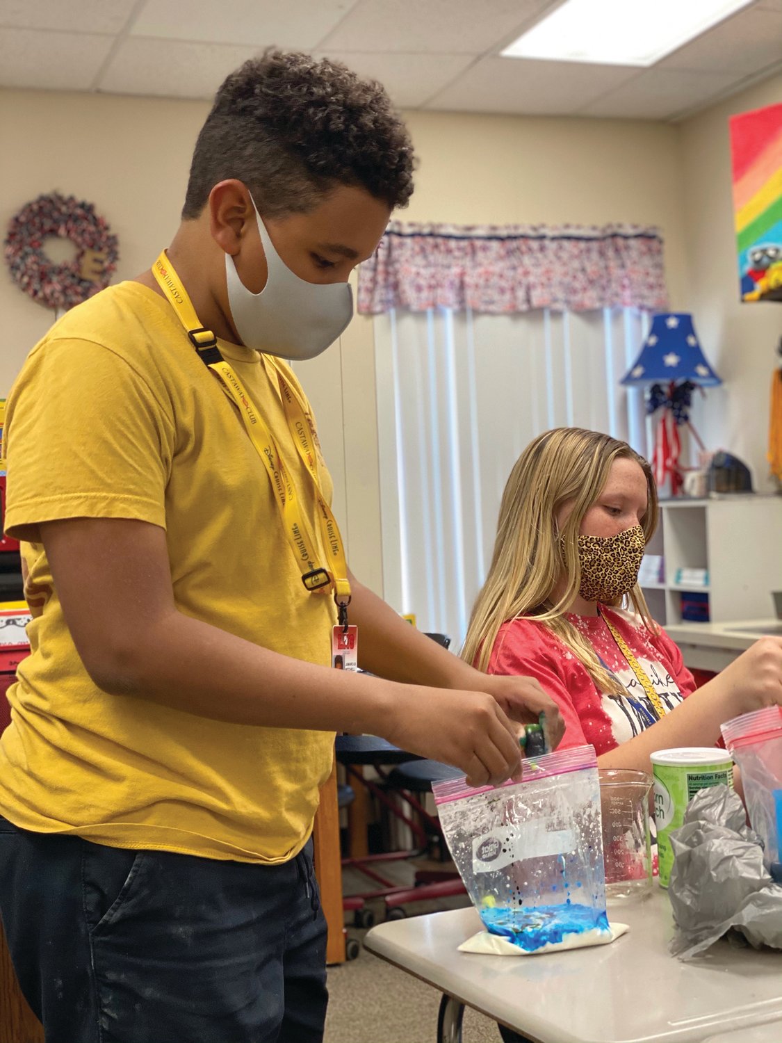 LaBelle Middle School Science Club students, Jamarcus Mitchell and Kaydence Swanson add food coloring to their Oobleck.